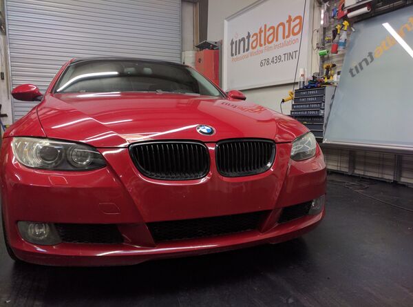 Red BMW Coupe front view with dark window tint by Tint Waco